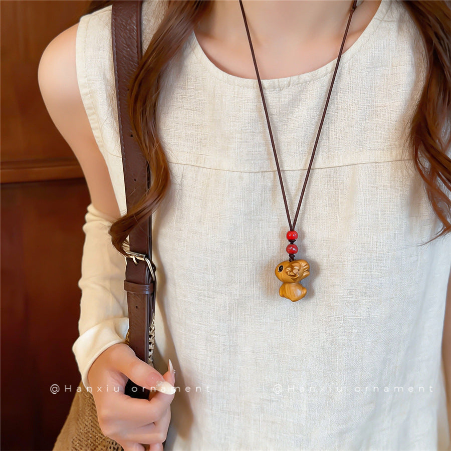 Chinese-Inspired Wooden Flower and Ceramic Sheep Pendant Necklace - view 3